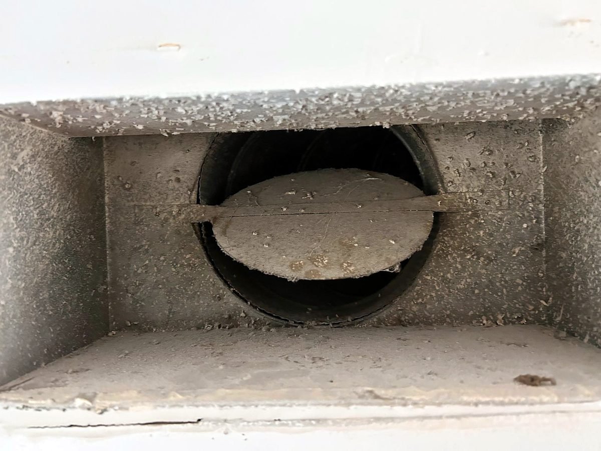 Register boot and damper coated in dust